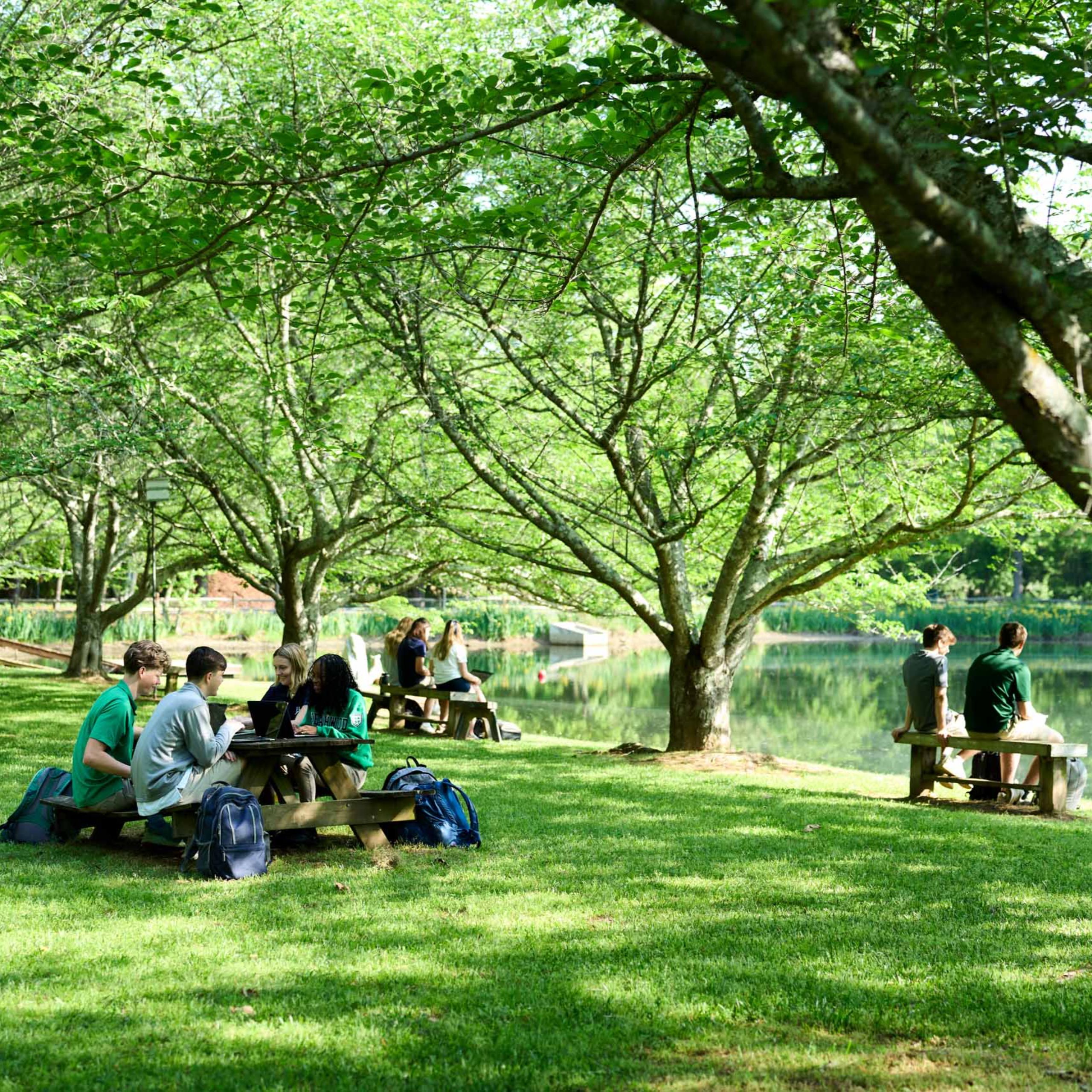 children in field sitting together on grass